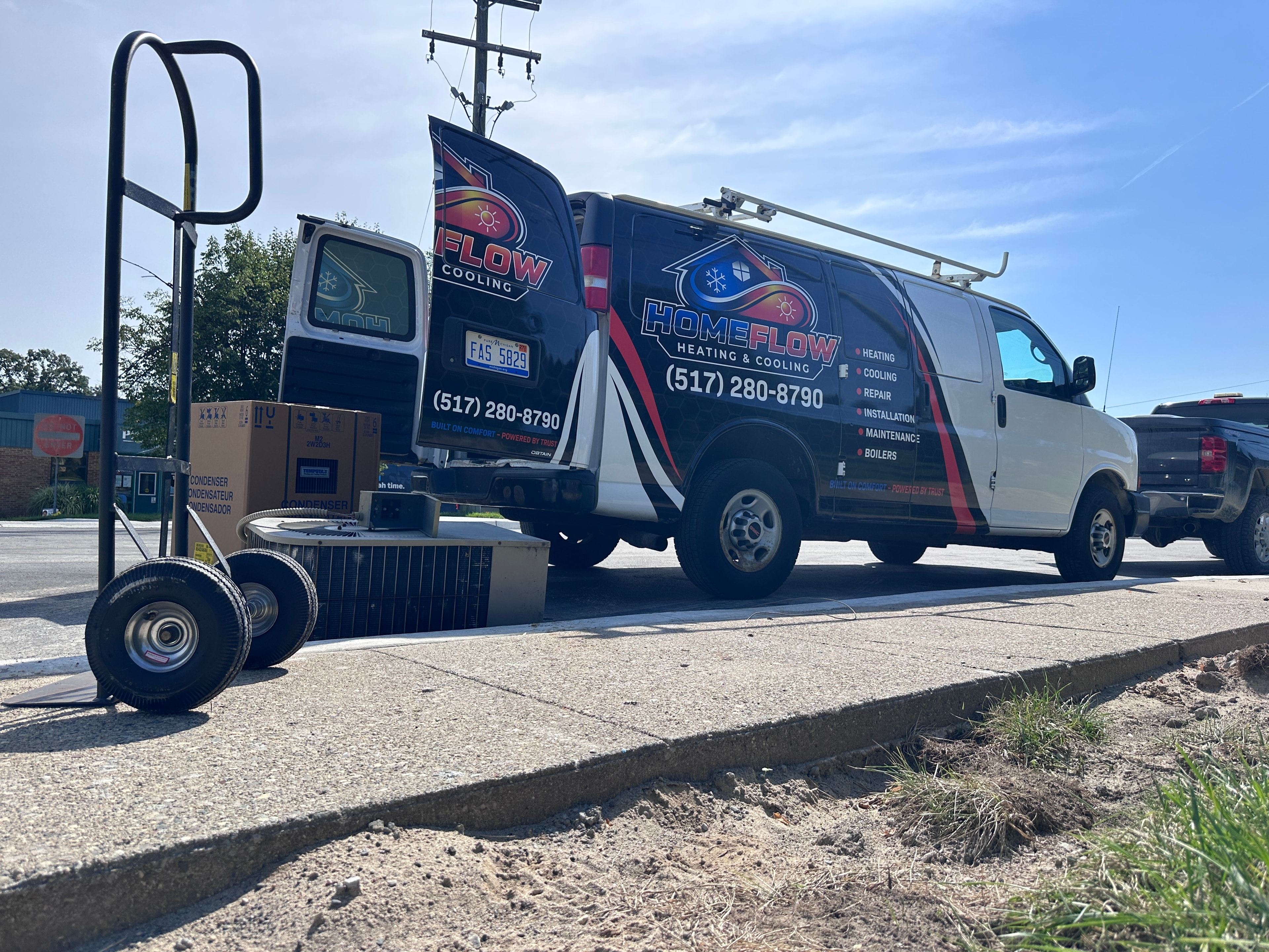 HomeFlow Heating & Cooling service van with HVAC equipment on a hand truck, ready for a Chelsea-area service call