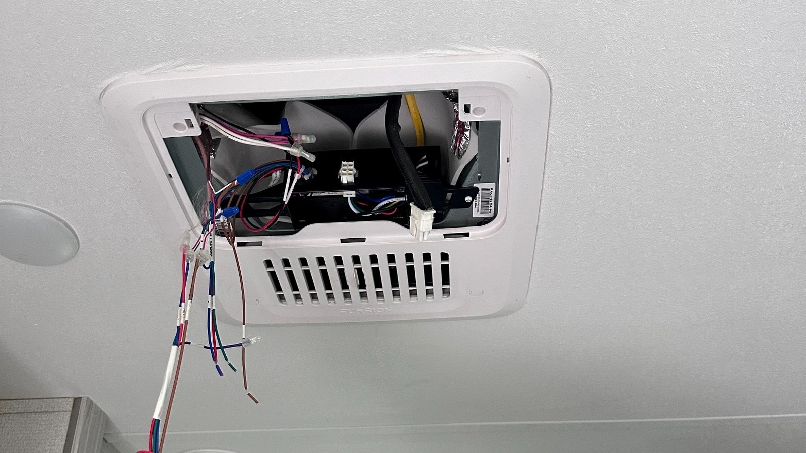 HomeFlow technician servicing an open ceiling cassette mini split unit